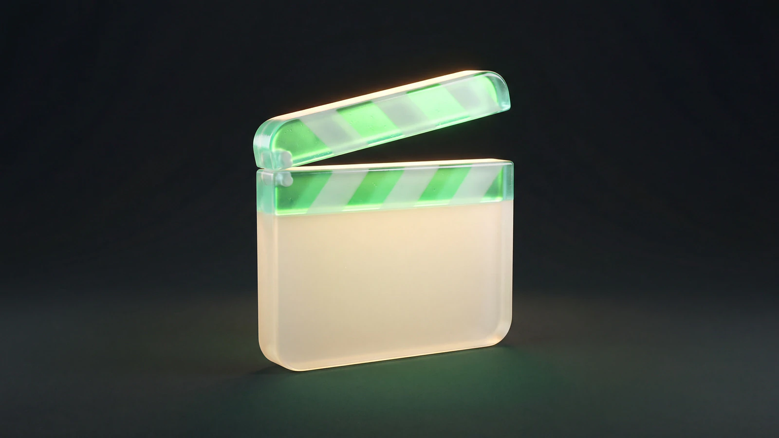 A frosted opal-glass film clapperboard with a green liquid-glass striped top bar and a blank slate, representing UGC ads produced and tested as planned paid creative.